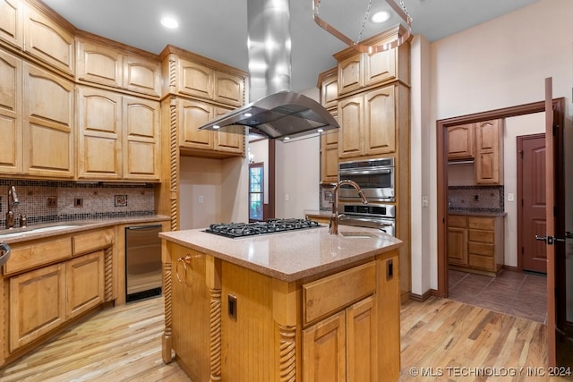 kitchen featuring island exhaust hood, light wood-type flooring, a kitchen island, and stainless steel appliances