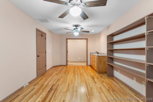 interior space with sink and ceiling fan