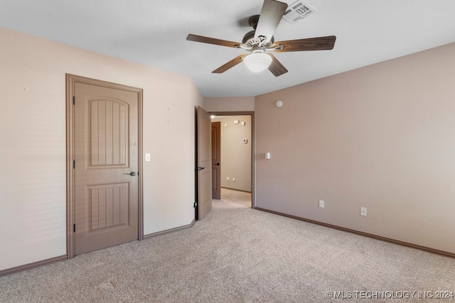 unfurnished bedroom with light carpet and ceiling fan