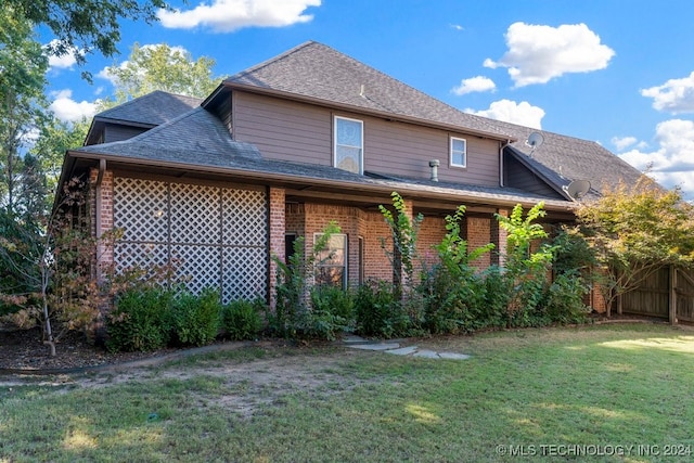 back of property with a lawn