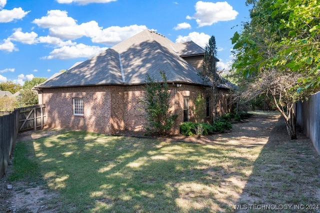 view of side of home featuring a yard