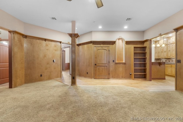 unfurnished living room with light carpet and a barn door