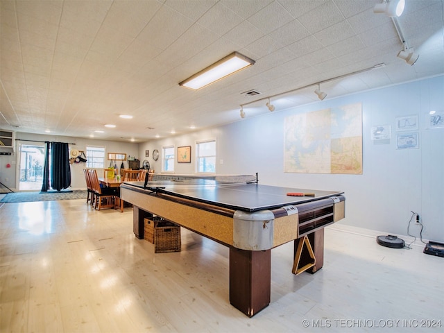 recreation room with a wealth of natural light, rail lighting, and light hardwood / wood-style flooring