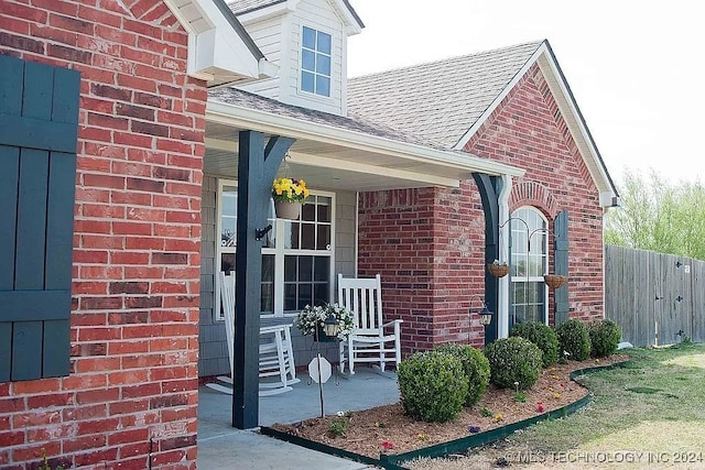 view of exterior entry with a porch