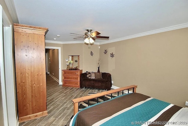 bedroom with ornamental molding, ceiling fan, and hardwood / wood-style floors