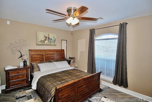 bedroom with dark wood-type flooring and ceiling fan