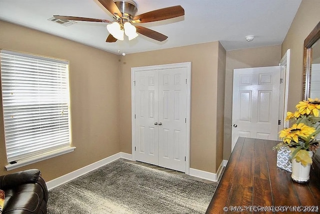 foyer entrance with ceiling fan and dark hardwood / wood-style floors