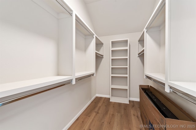 spacious closet featuring light hardwood / wood-style floors