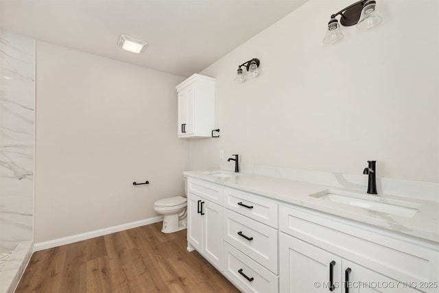 bathroom with vanity, hardwood / wood-style floors, and toilet