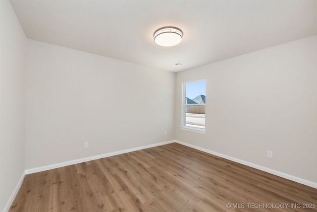 spare room with light hardwood / wood-style flooring