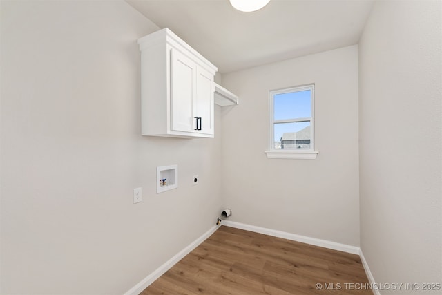 washroom featuring hardwood / wood-style flooring, cabinets, washer hookup, and electric dryer hookup