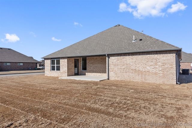 back of property featuring a yard, central AC unit, and a patio