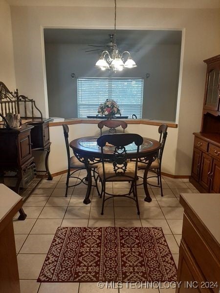 dining room featuring light tile patterned flooring and a notable chandelier