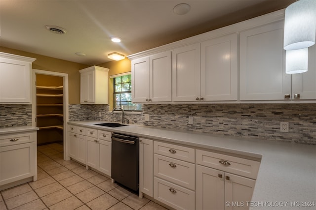 kitchen featuring decorative backsplash, white cabinets, dishwasher, light tile patterned floors, and sink