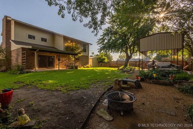 view of yard featuring a patio area and an outdoor fire pit