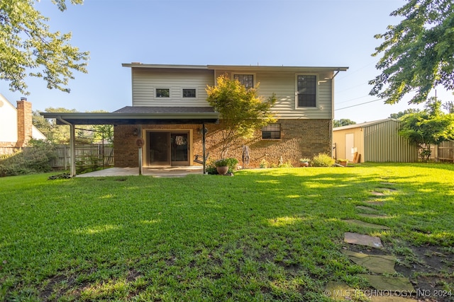 rear view of house featuring a shed, a yard, and a patio area