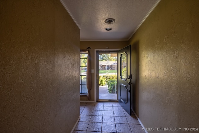 doorway featuring a textured ceiling and crown molding