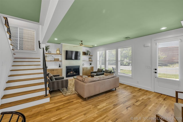 living room featuring ceiling fan and light hardwood / wood-style flooring