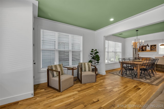 sitting room with a chandelier and light hardwood / wood-style floors