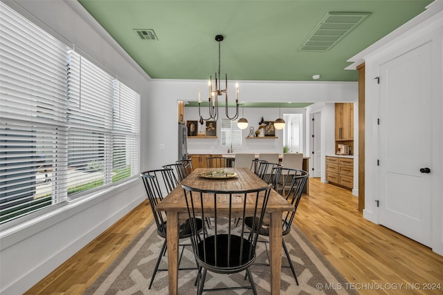 dining room with an inviting chandelier and light hardwood / wood-style floors