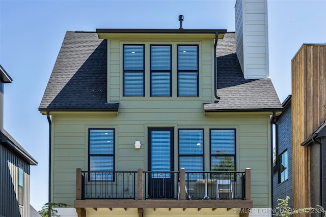 rear view of property featuring a balcony