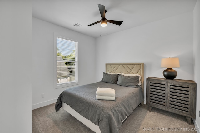 bedroom featuring ceiling fan and light carpet