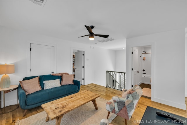 living room featuring ceiling fan and light hardwood / wood-style flooring