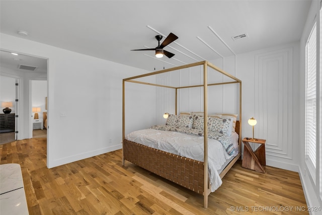 bedroom with light hardwood / wood-style floors and ceiling fan