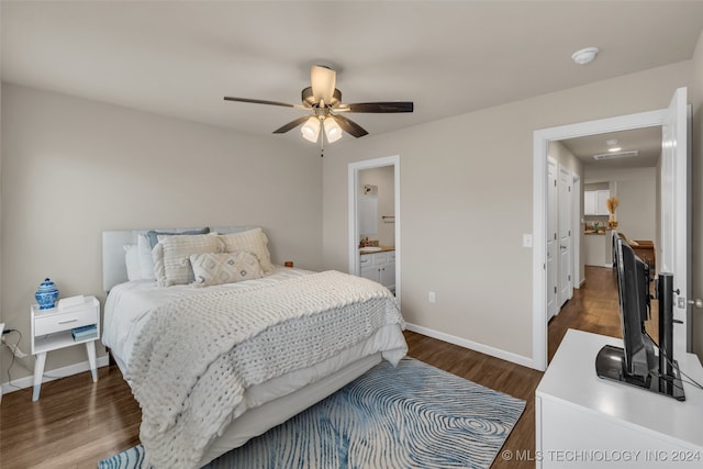 bedroom with dark hardwood / wood-style floors, ceiling fan, and ensuite bath