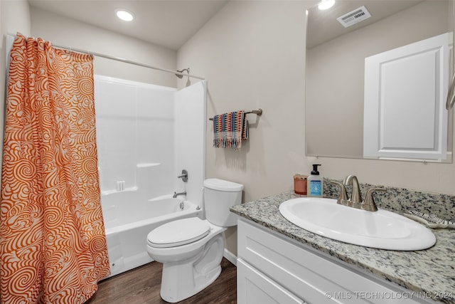 full bathroom featuring shower / bath combo with shower curtain, vanity, hardwood / wood-style floors, and toilet