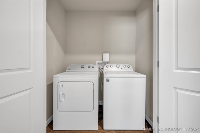 clothes washing area with washer and clothes dryer