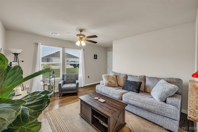 living room with light hardwood / wood-style floors and ceiling fan