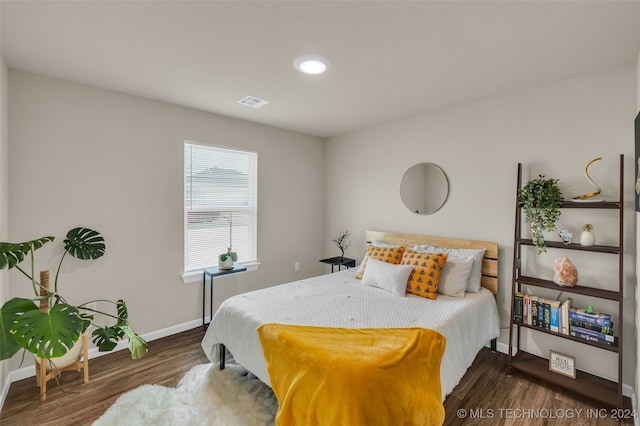 bedroom with dark wood-type flooring