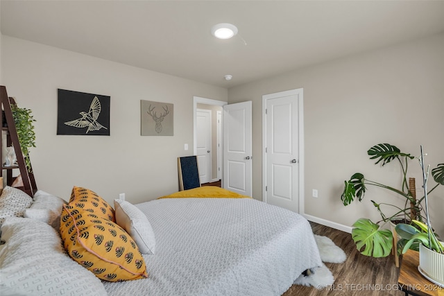 bedroom with wood-type flooring