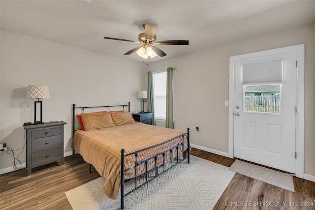 bedroom featuring multiple windows, ceiling fan, and hardwood / wood-style flooring