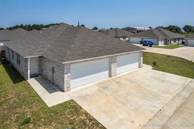 view of property exterior with a lawn, central air condition unit, and a garage