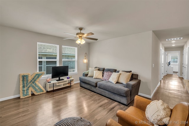 living room with hardwood / wood-style floors, ceiling fan, and a healthy amount of sunlight