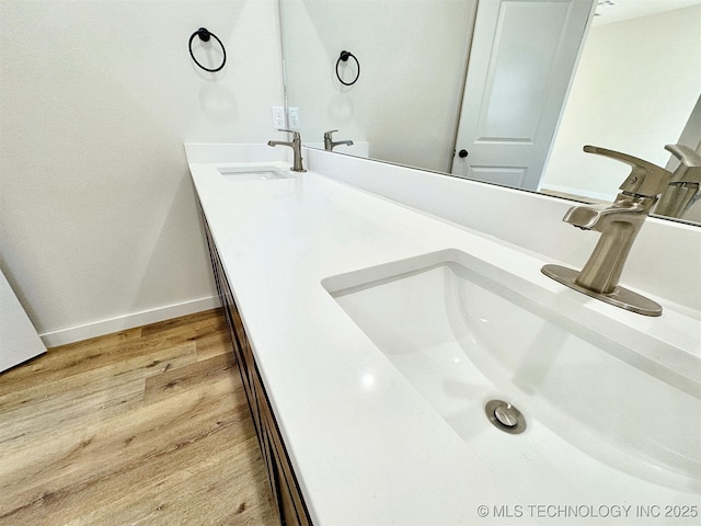 bathroom with hardwood / wood-style flooring and vanity