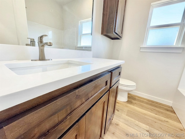 bathroom featuring vanity, hardwood / wood-style floors, and toilet