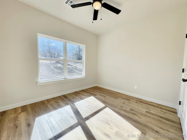 unfurnished room with light wood-style floors, visible vents, ceiling fan, and baseboards