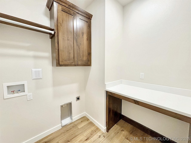 laundry room with washer hookup, baseboards, light wood-type flooring, cabinet space, and electric dryer hookup