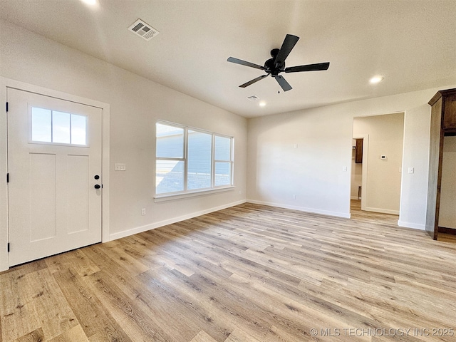 foyer entrance with light wood-type flooring, visible vents, and baseboards