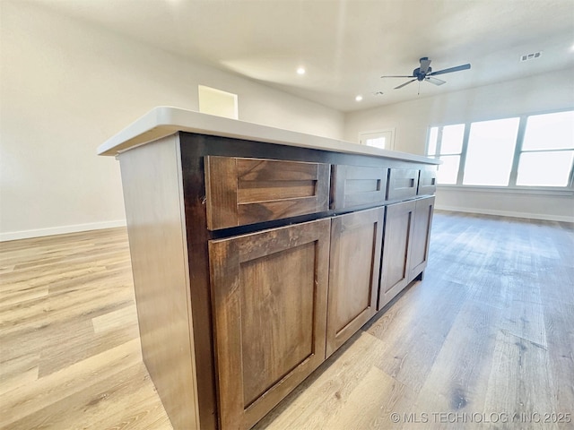 kitchen with light wood-style floors, visible vents, baseboards, and a ceiling fan