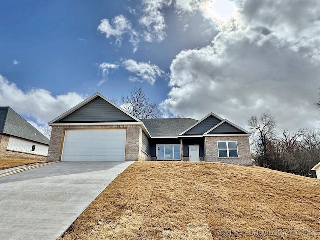 ranch-style house featuring driveway, brick siding, and an attached garage