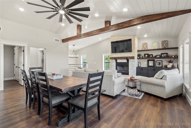 dining room with beamed ceiling, dark wood-type flooring, high vaulted ceiling, a fireplace, and ceiling fan with notable chandelier