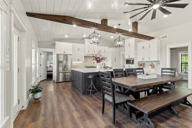 dining area with wood ceiling, lofted ceiling with beams, dark hardwood / wood-style floors, and sink