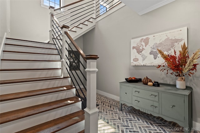 stairway featuring ornamental molding