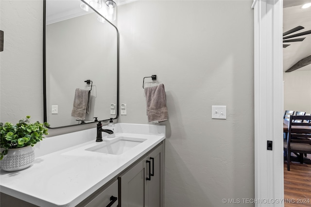 bathroom featuring crown molding, vanity, and hardwood / wood-style flooring