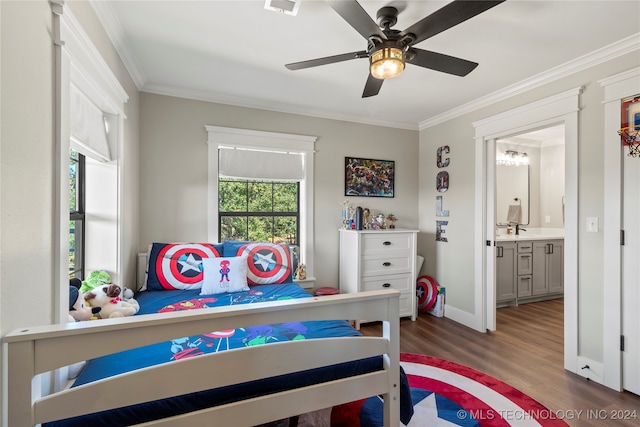 bedroom with connected bathroom, ornamental molding, dark wood-type flooring, and ceiling fan