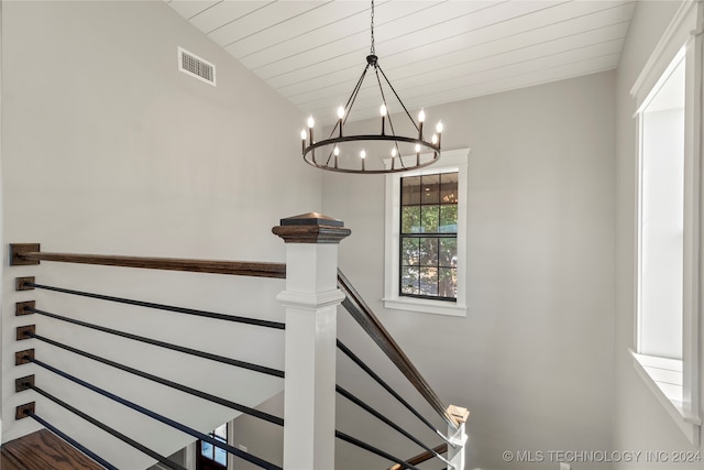 stairs with wood ceiling, vaulted ceiling, and an inviting chandelier